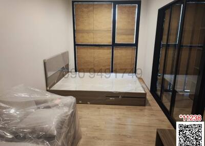 Unfurnished bedroom with large wardrobe and hardwood flooring