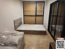 Unfurnished bedroom with large wardrobe and hardwood flooring