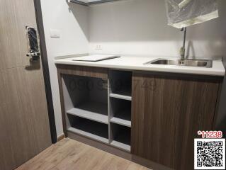 Modern compact kitchen with wooden cabinets and stainless steel sink