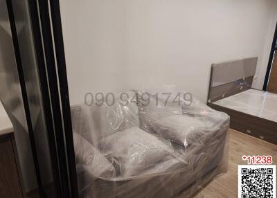 Newly furnished bedroom with bed wrapped in plastic