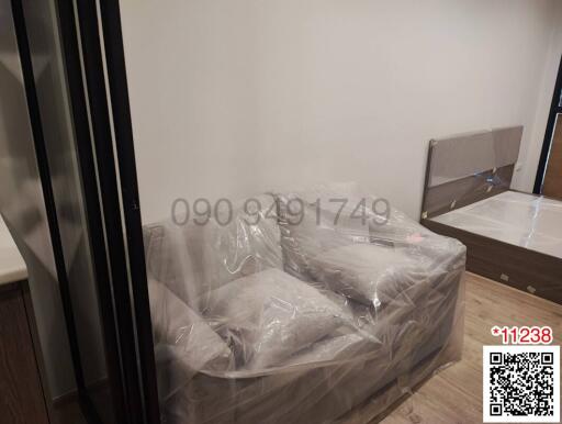 Newly furnished bedroom with bed wrapped in plastic