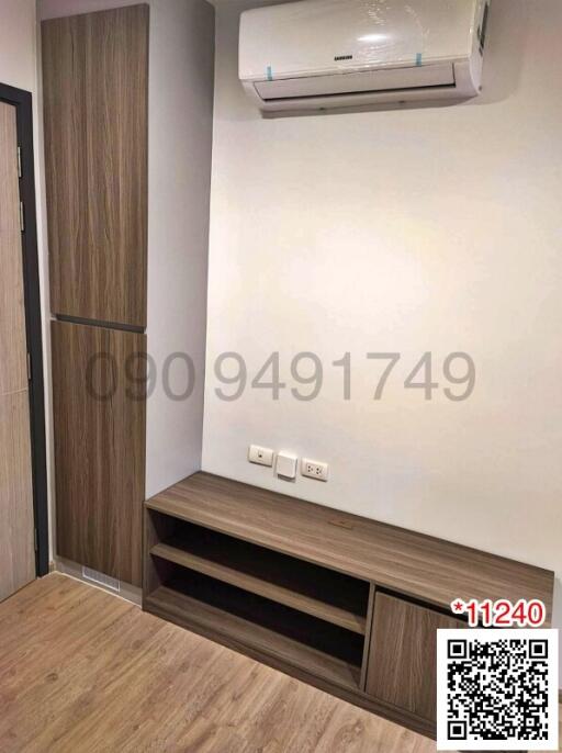 Compact bedroom with wooden furniture and air conditioning