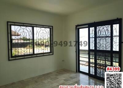 Spacious bedroom with large windows and a balcony door