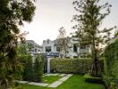 Lush garden and exterior of a luxurious home at dusk