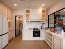 Modern kitchen with wooden floor and white cabinets