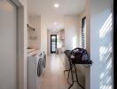 Compact laundry room with modern appliances and ample storage space