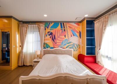 Bright and colorful bedroom with artistic wall design and modern furniture