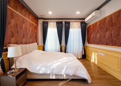 Cozy bedroom with decorative wallpaper and modern air conditioning unit