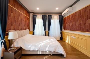 Cozy bedroom with decorative wallpaper and modern air conditioning unit