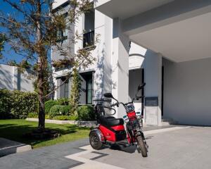 Modern home exterior with a parked scooter