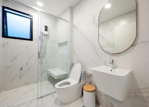 Modern bathroom with glass shower and marble finish