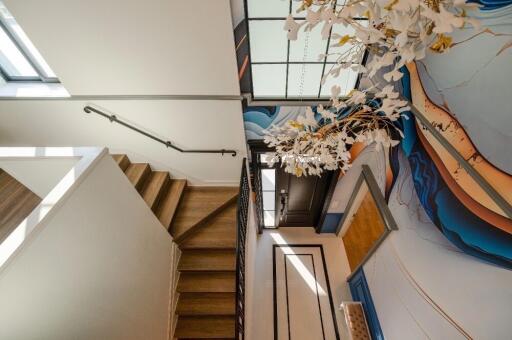 Modern staircase with artistic wall design in a home interior