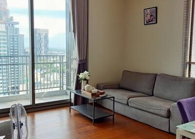 Spacious and well-lit living room with modern furniture and city view