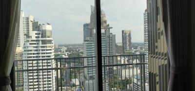 City view from a high-rise apartment balcony