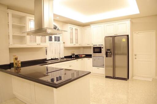 Modern kitchen with white cabinets and stainless steel appliances