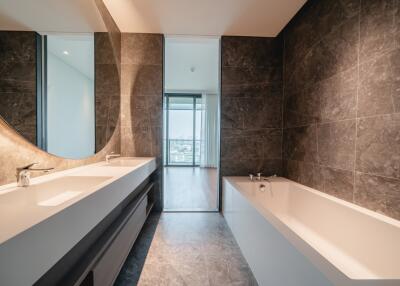 Modern bathroom with a large mirror and abundant natural light