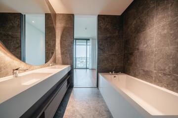 Modern bathroom with a large mirror and abundant natural light