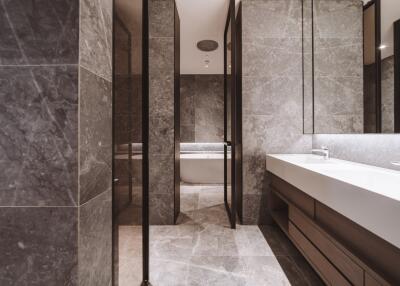 Modern bathroom interior with marble tiles and glass partition