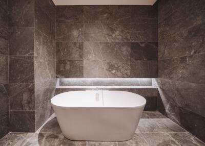 Modern bathroom with a freestanding tub and marble tiles