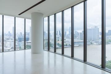 Spacious living room with floor-to-ceiling windows overlooking the city