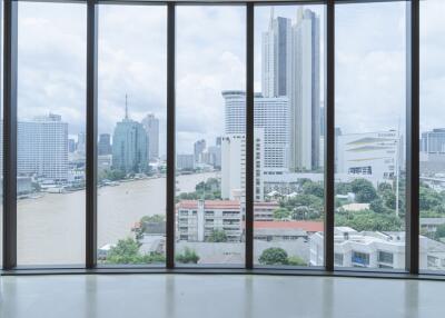 Spacious room with a panoramic view of the city skyline and river