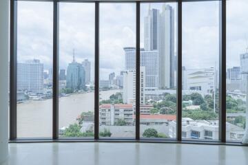 Spacious room with a panoramic view of the city skyline and river