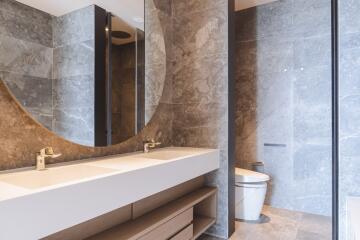 Modern bathroom with marble tiles and sleek fixtures