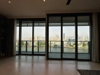 Spacious living room with large windows and city view