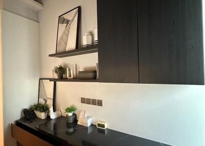 Modern living space with sleek black shelving and decor