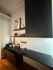 Modern living space with sleek black shelving and decor