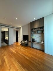 Modern living room with wooden flooring and built-in shelves
