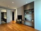 Modern living room with wooden flooring and built-in shelves