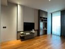 Modern living room with wooden flooring, large window and built-in shelving