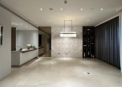 Contemporary building entrance with elegant lighting and marble wall design