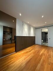 Modern interior design of a spacious building with hardwood floors and artistic wall