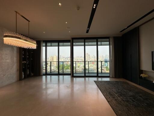 Spacious and modern living room with large windows and city view