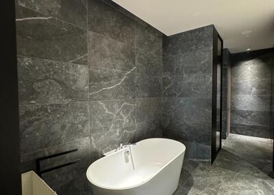Modern bathroom with standalone bathtub and marble finishes