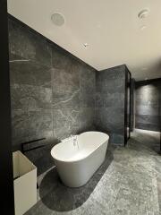 Modern bathroom with standalone bathtub and marble finishes