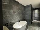 Modern bathroom with standalone bathtub and marble finishes