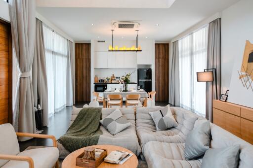 Modern living room seamlessly connected to a well-equipped open kitchen