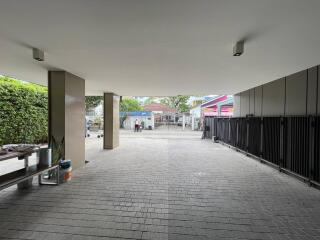 Spacious building entrance with paving and pillars