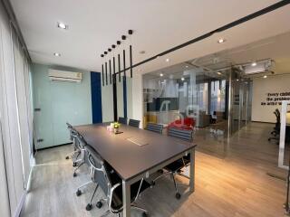 Modern office space with meeting area and glass partitions