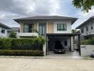 Modern two-story residential home with garage and a car parked outside