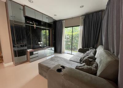 Modern living room with large windows and dark curtains