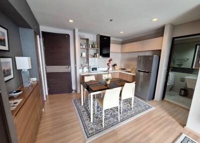 Modern open-plan kitchen and dining area with wooden flooring