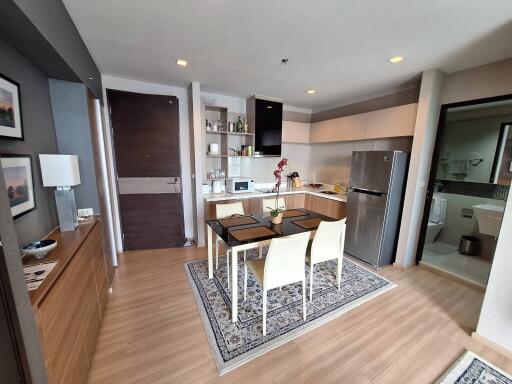 Modern open-plan kitchen and dining area with wooden flooring