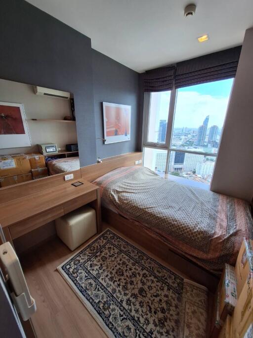 Cozy bedroom with a city view and a work desk