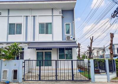 Modern two-story residential house with a gate