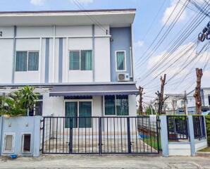 Modern two-story residential house with a gate