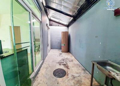 Building interior hallway with glass paneling and concrete floor